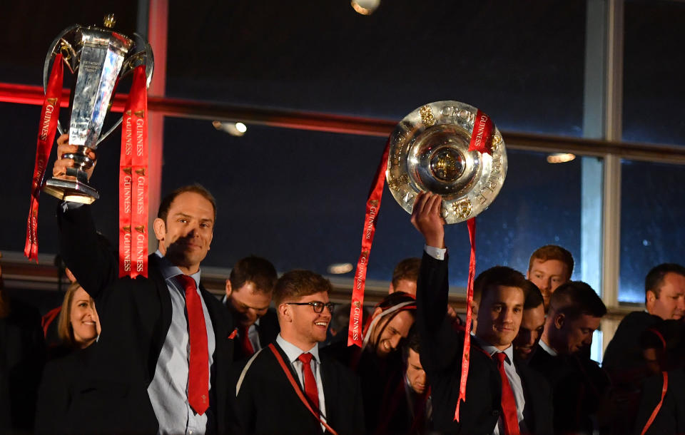 Wales captain Alun Wyn Jones (left) and Jonathan Davies lift the Six Nations trophy and Triple Crown trophy during the 2019 Guinness Six Nations Grand Slam winners celebration welcome at the Senedd in Cardiff Bay. (Photo by Simon Galloway/PA Images via Getty Images)