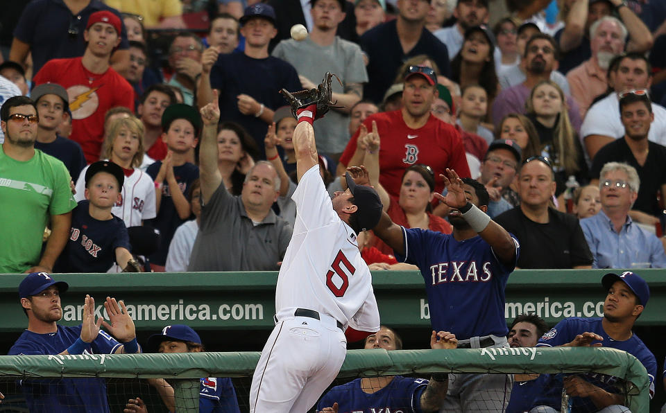 Nick Punto #5 of the Boston Red Sox makes a catch on a foul ball against the Texas Rangers at Fenway Park August 7, 2012 in Boston, Massachusetts. (Photo by Jim Rogash/Getty Images)