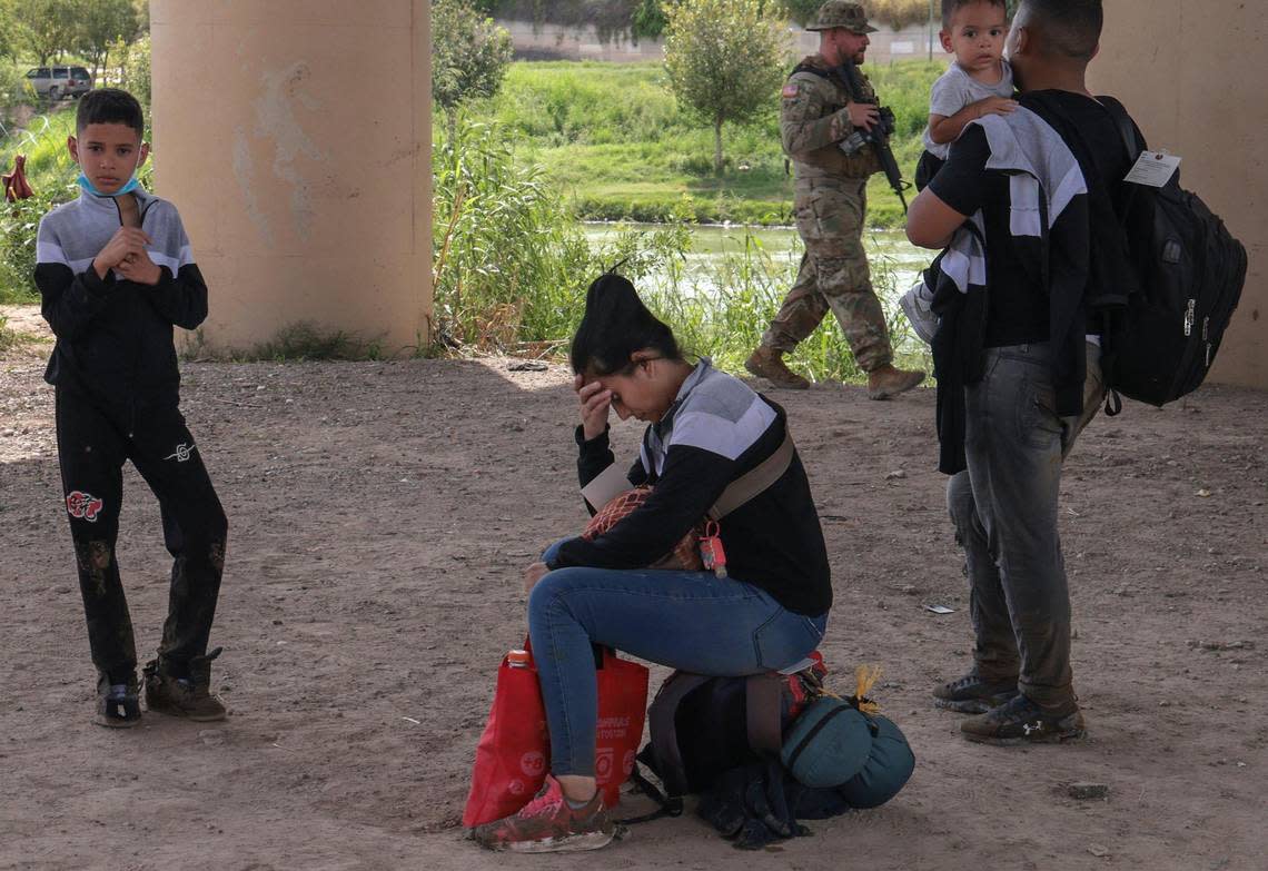 Upon completing the arduous journey from Venezuela to the U.S.- Mexico border outpost Eagle Pass, a woman who gave her name as Carolina waits for Border agents on Sunday, Sept. 18, 2022.