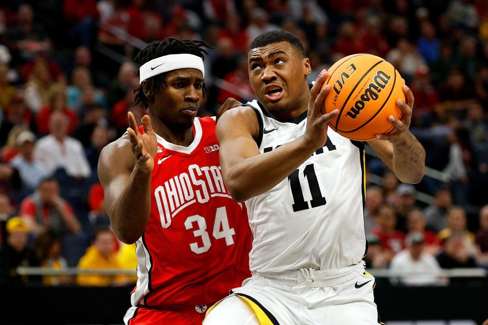 MINNEAPOLIS, MINNESOTA - MARCH 14: Tony Perkins #11 of the Iowa Hawkeyes drives to the basket against Felix Okpara #34 of the Ohio State Buckeyes in the first half in the Second Round of the Big Ten Tournament at Target Center on March 14, 2024 in Minneapolis, Minnesota. (Photo by David Berding/Getty Images)