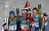 Cross-Country Skiing - Pyeongchang 2018 Winter Olympics - Women's 30km Mass Start Classic - Alpensia Cross-Country Skiing Centre - Pyeongchang, South Korea - February 25, 2018 - Gold medallist Marit Bjoergen of Norway poses between silver medallist Krista Parmakoski of Finland and bronze medallist Stina Nilsson of Sweden. REUTERS/Toby Melville