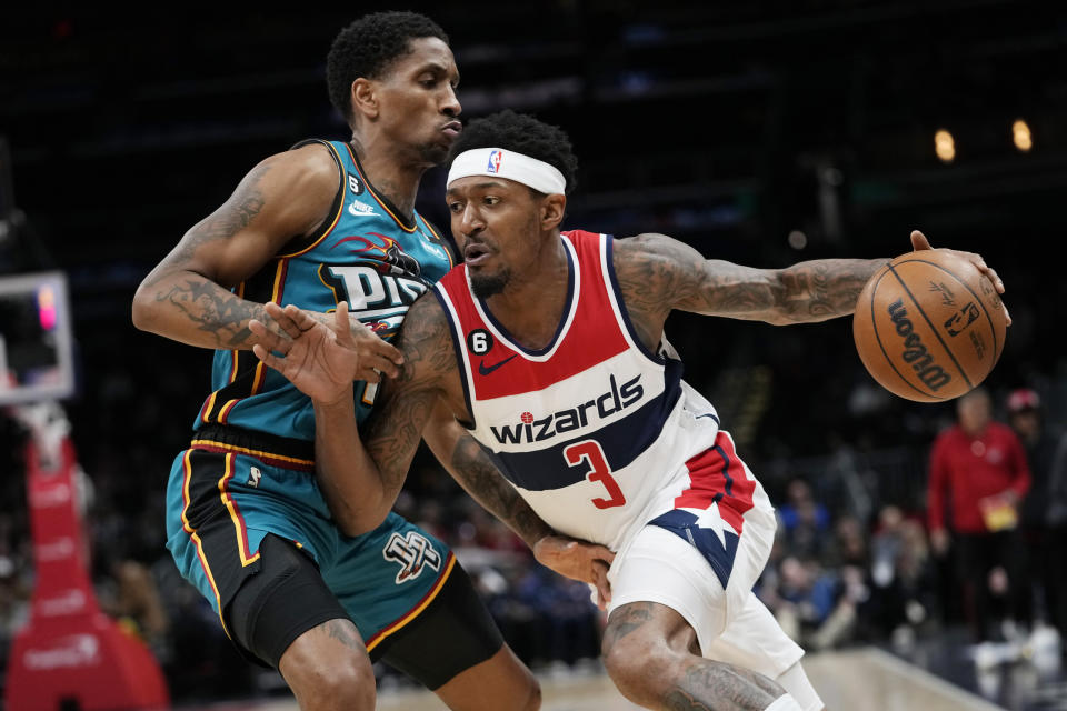 Washington Wizards guard Bradley Beal (3) drives around Detroit Pistons guard Rodney McGruder during the first half of an NBA basketball game Tuesday, March 14, 2023, in Washington. (AP Photo/Carolyn Kaster)