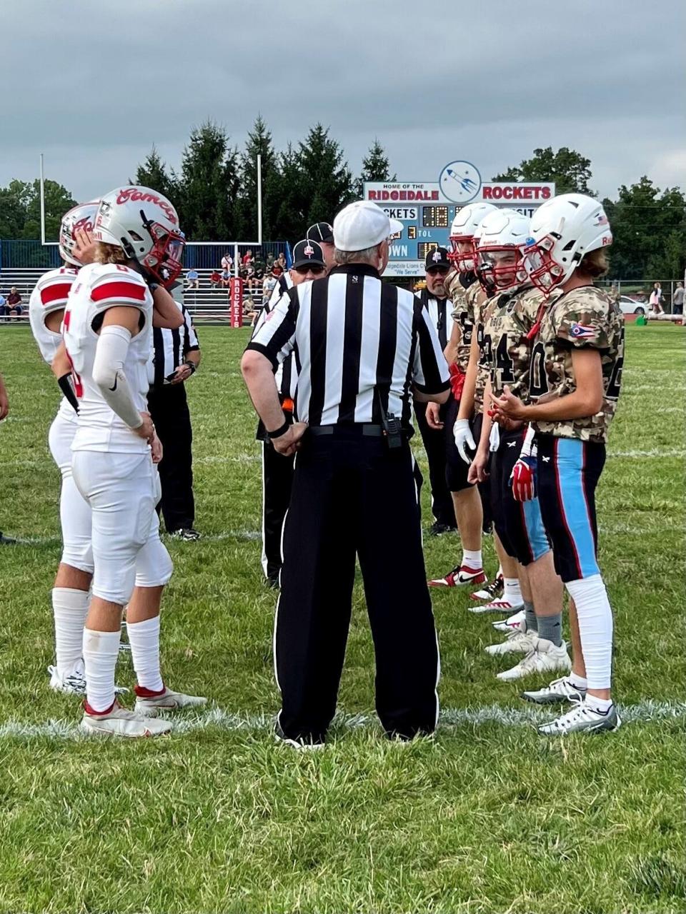 Elgin and Ridgedale football captains meet for the coin toss before Friday's Week 2 county showdown between the two Northwest Central Conference schools in 2023.