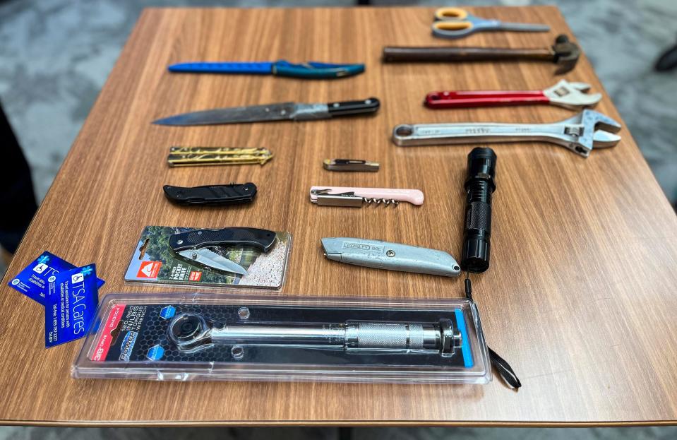 A sample of prohibited items seized by U.S. Transportation Security Administration staff at Evansville Regional Airport are displayed on a table Tuesday, Sept. 27, 2023, ahead of the fall travel season.