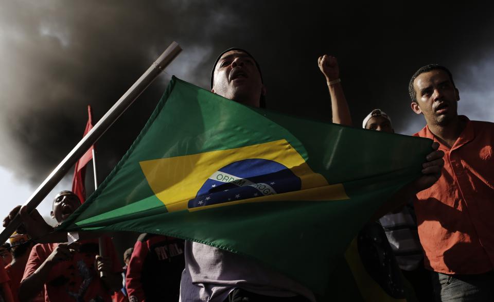 Members of Brazil's Homeless Workers' Movement (MTST), who are living at the "People's World Cup Camp" which houses some 2,800 families of the movement in the district of Itaquera near Sao Paulo's World Cup stadium, Arena de Sao Paulo, block a road during a protest against the 2014 World Cup in Sao Paulo, May 15, 2014.Cities across Brazil braced for demonstrations on Thursday, as disparate protest movements seek to criticize spending on the upcoming World Cup soccer tournament and revive a call for better public services that swept the country last June. Though most demonstrations are expected to gain steam later in the day, protestors in Sao Paulo, the country's biggest city, by early morning had blocked a major thoroughfare with burning tires and disrupted commutes elsewhere. REUTERS/Nacho Doce (BRAZIL - Tags: SPORT SOCCER WORLD CUP CIVIL UNREST)