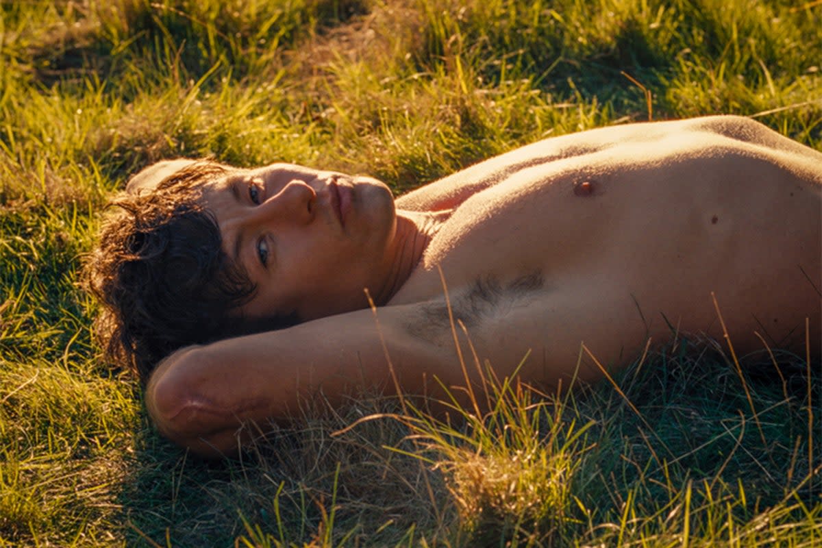 Barry Keoghan’s Oliver Quick lounges on the grass in ‘Saltburn’  (Prime Video)