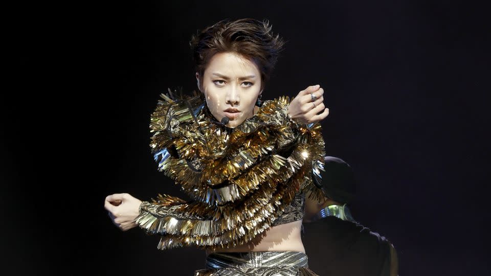 Chinese singer Xin Liu (who also goes by Liu Yuxin) performed in a hypnotic gold metallic set by London-based designer Syban Velardi-laufer. - Frazer Harrison/Getty Images for Coachella