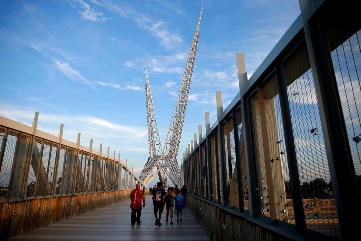 People walk across the Skydance Bridge on June 10 in Scissortail Park in Oklahoma City.