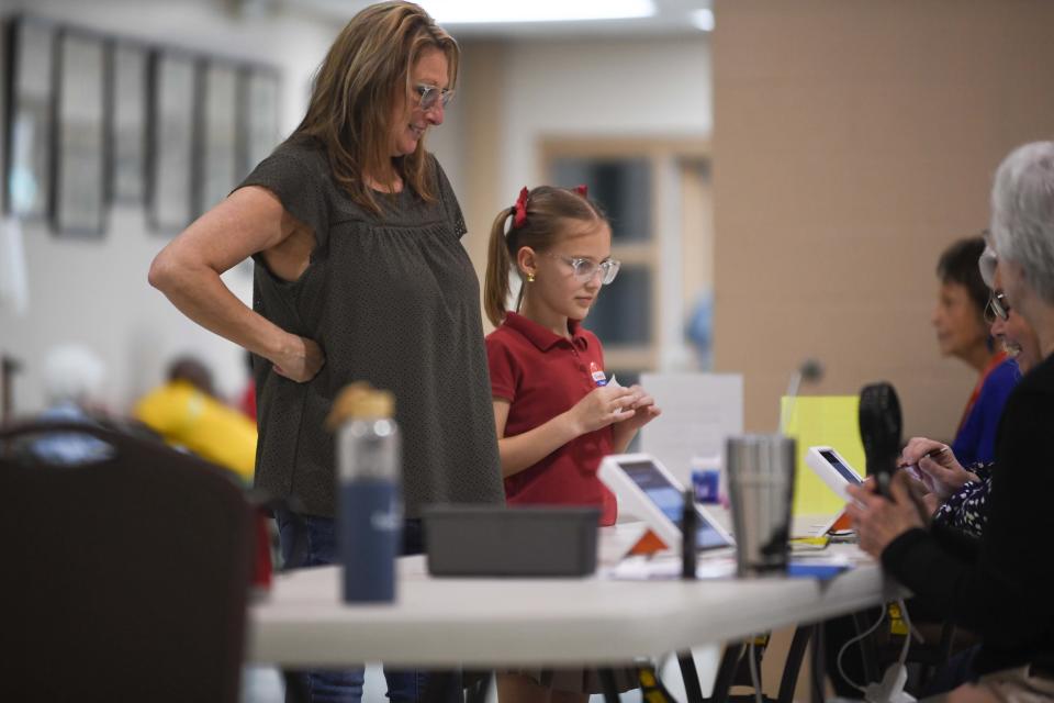 A voter checks in with poll workers before casting their ballot during the March 5 Presidential and Madison County Primary Election in Jackson, Tenn. on Tuesday, March 5, 2024.