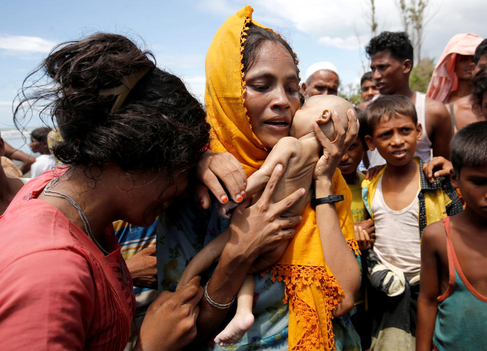 <p>Hamida, a Rohingya refugee woman cries as she holds the body of her 40-day-old son, who died when a boat capsized at the shore of Shah Porir Dwip, in Teknaf, Bangladesh, September 14, 2017. (Photo: Mohammad Ponir Hossain/Reuters) </p>