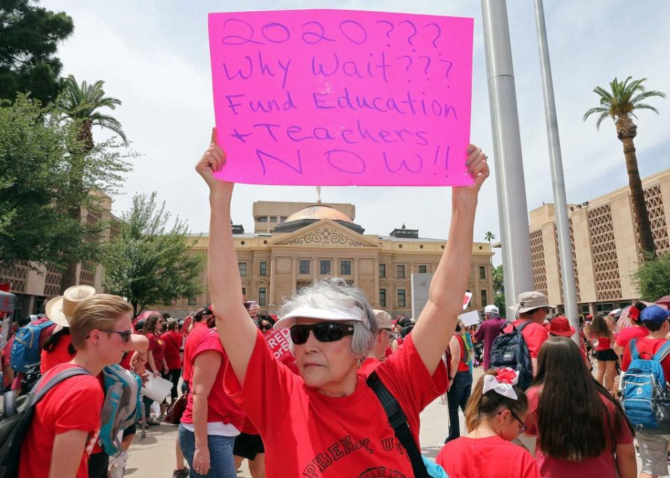 Teachers throughout Arizona, including this group in Phoenix, staged a walkout strike in 2018 in support of better wages and state funding for schools. In November 2020, the state passed Proposition 208 to put a 3.5 percent income tax surcharge on people making more than $250,000, with the money designated for education.