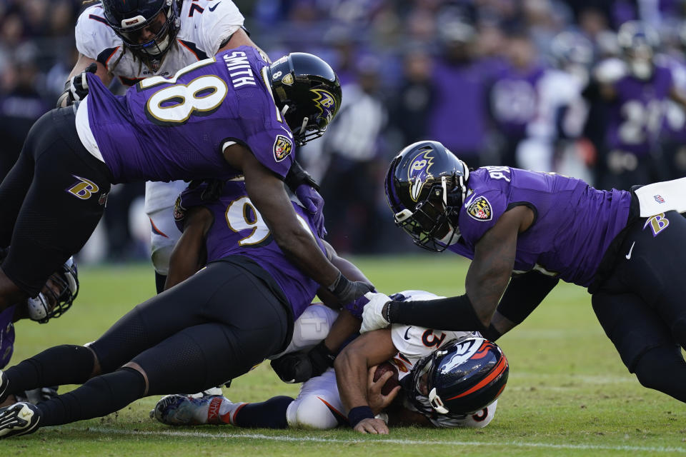 Denver Broncos quarterback Russell Wilson (3) gets sacked by Baltimore Ravens linebacker Odafe Oweh (99), Baltimore Ravens linebacker Roquan Smith (18), and Baltimore Ravens linebacker Jason Pierre-Paul (4), in the second half of an NFL football game, Sunday, Dec. 4, 2022, in Baltimore. (AP Photo/Patrick Semansky)