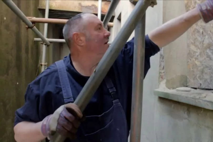 Keith surveys walls and windows at the chapel and considers how best to save them