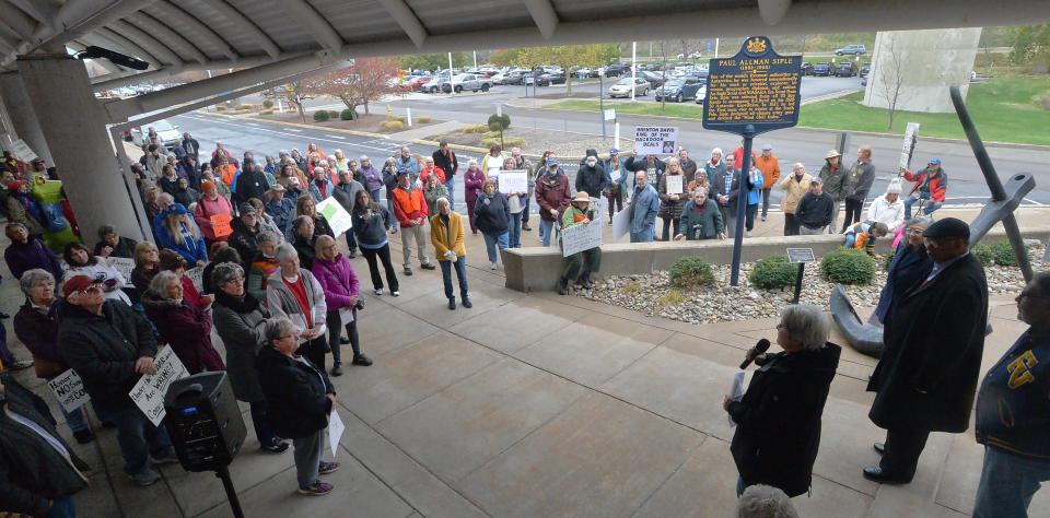 More than 100 people attend a public rally, to oppose the leasing of space at Blasco Memorial Library for a university water research center, in front of the library in Erie on Nov. 4, 2023. Organizers are protesting a 25-year lease agreement that was recently approved between the county and Gannon University.