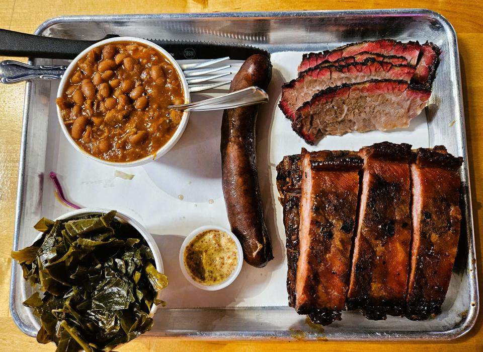 The “Texas Holy Trinity” of ribs, brisket and a hot link with spicy mustard as well as collard greens and smoked baked beans with pork at Nancy's Bar-B-Q (1525 4th St., Sarasota) photographed Sept. 23, 2023.