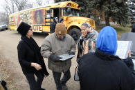 FILE - In this Tuesday, Nov. 6, 2018 file photo Judith LeBlanc, left, with Four Directions, a non-profit voting equality organization for Native Americans, helps local volunteers before going door-to-door looking for voters in Selfridge, N.D., and offering a free bus ride to the polling precinct. On Friday, Aug. 23, 2019, The Associated Press reported on stories circulating online incorrectly asserting that a court upheld a North Dakota law stripping voting rights from Native Americans. They are still eligible to vote in the state. A change to North Dakota’s voter ID law, however, has been criticized for potentially suppressing Native American votes. (Mike McCleary/The Bismarck Tribune via AP)