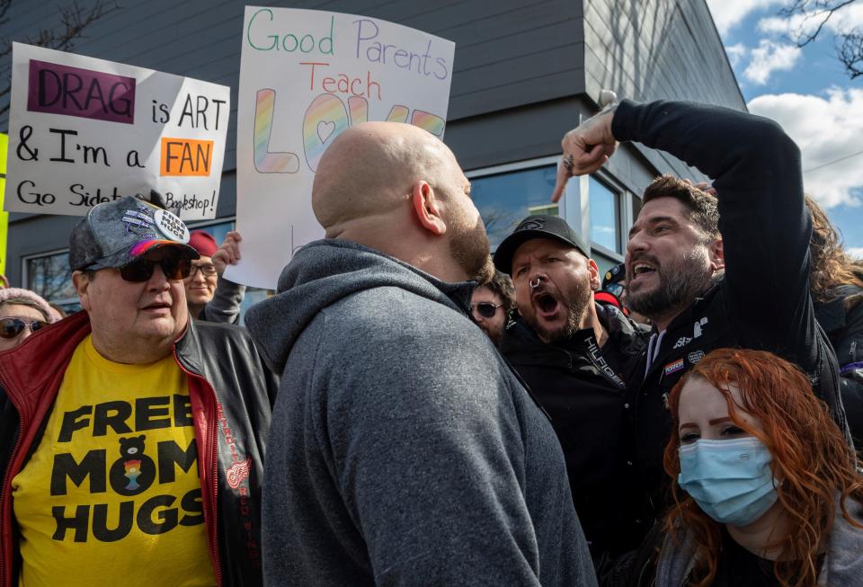 Phillip Martin, Ryan Logan, and others shouted "Go home, bigot" to Hassan Aoun, center, outside Sidetrack Bookshop as hundreds of protesters showed up outside the bookstore to support Drag Queen Story Time in Royal Oak on Saturday, March 11, 2023.