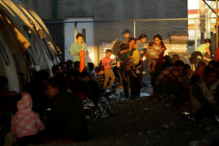 Central American migrants are seen inside an enclosure where they are being held by U.S. Customs and Border Protection (CBP), after crossing the border between Mexico and the United States illegally and turning themselves in to request asylum, in El Paso, Texas, March 28, 2019. REUTERS/Jose Luis Gonzalez