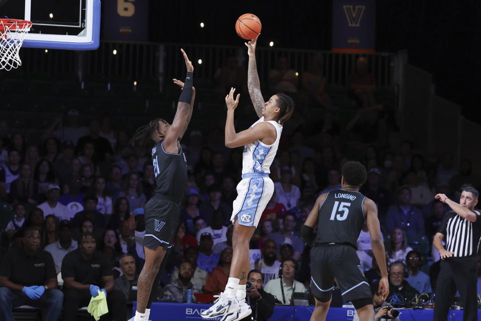 In a photo provided by Bahamas Visual Services, North Carolina's Armando Bacot shoots over Villanova's Nnanna Njoku during an NCAA college basketball game in the Battle 4 Atlantis at Paradise Island, Bahamas, Thursday, Nov. 23, 2023. (Tim Aylen/Bahamas Visual Services via AP)