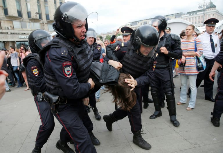 Russian police officers detain participants of an unauthorized opposition rally in Tverskaya street in central Moscow on June 12, 2017
