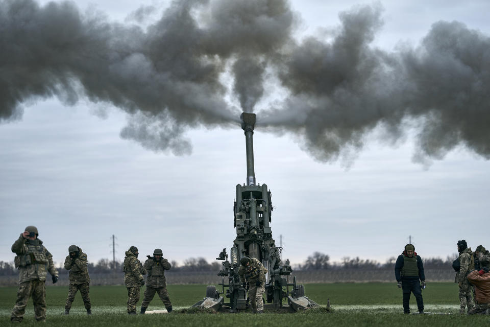 FILE - Ukrainian soldiers fire at Russian positions from a U.S.-supplied M777 howitzer in Kherson region, Ukraine, Jan. 9, 2023. A rapidly expanding group of U.S. and allied troops and contractors are using phones and tablets to communicate in encrypted chat rooms to provide real-time maintenance advice to Ukrainian troops on the battlefield. As the U.S. and other allies provide a growing number of increasingly complex and high-tech weapons, the maintenance demands are expanding. (AP Photo/Libkos, File)
