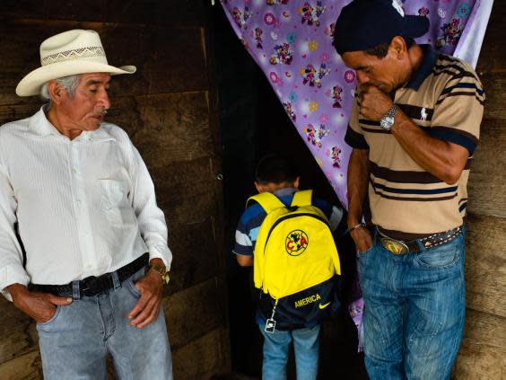 Carrillo’s son shows his father’s friends the Club America backpack he will use when he travels through Mexico towards the US (Sarah L Voisin/Washington Post)