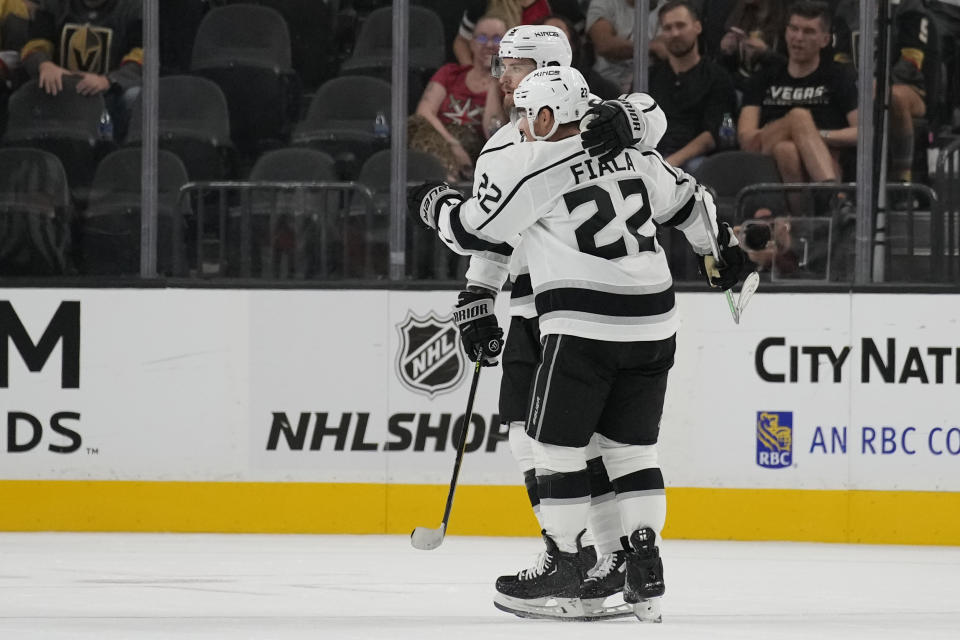 Los Angeles Kings left wing Kevin Fiala (22) celebrates after Los Angeles Kings center Adrian Kempe, left, scored during overtime of an NHL preseason hockey game Monday, Sept. 26, 2022, in Las Vegas. (AP Photo/John Locher)