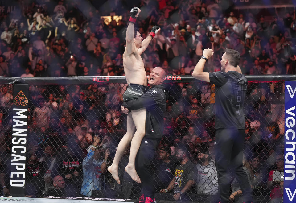 Mike Malott celebrates after defeating Adam Fugitt by submission during a welterweight bout at UFC 289 in Vancouver, British Columbia on Saturday, June 10, 2023. (Darryl Dyck/The Canadian Press via AP)