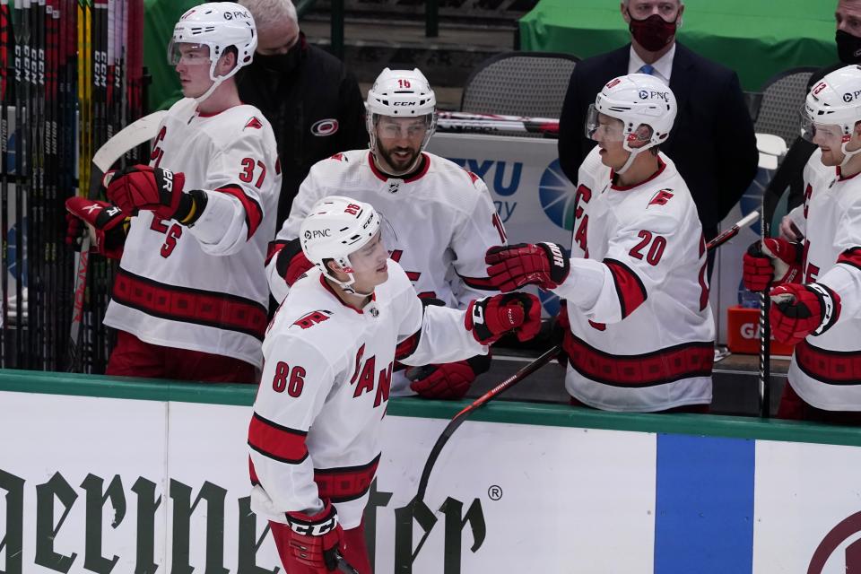 Carolina Hurricanes' Teuvo Teravainen (86) celebrates with Andrei Svechnikov (37), Vincent Trocheck (16), Sebastian Aho (20) and Warren Foegele, right rear, after Teravainen scored during the second period of the team's NHL hockey game against the Dallas Stars in Dallas, Saturday, Feb. 13, 2021. (AP Photo/Tony Gutierrez)