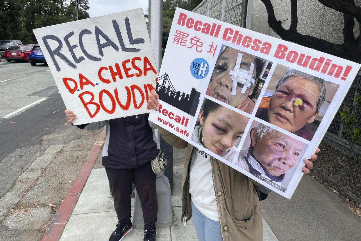 Volunteers on 19th Avenue in San Francisco hold signs that read: Recall DA Chesa Boudin.