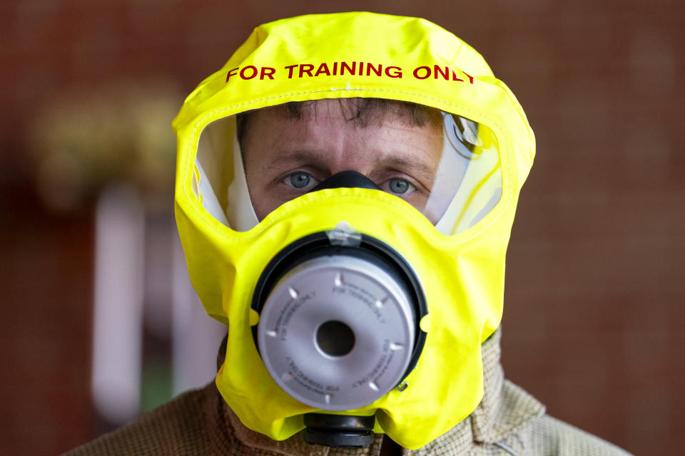 Firefighter wearing fire escape hood