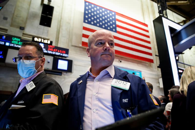 Traders work on the floor of the NYSE in New York