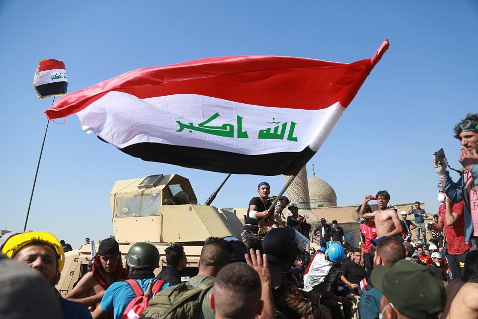 Anti-government protesters try to cross the al- Shuhada (Martyrs) bridge in central Baghdad, Iraq, Wednesday, Nov. 6, 2019. The rallies that have gripped in Iraq and similar demonstrations underway in Lebanon pose a threat to some of Iran's main regional allies as Tehran faces mounting pressure from U.S. sanctions. (AP Photo/Hadi Mizban)