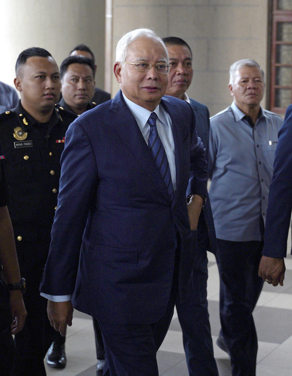 Former Prime Minister Najib Razak arrives at Kuala Lumpur High Court in Kuala Lumpur, Malaysia, Wednesday, Dec. 12, 2018. Najib and Former 1Malaysia Development Berhad CEO, Arul Kanda Kandasamy, face fresh charges for tempering 1MDB audit report. (AP Photo/Yam G-Jun)