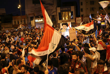 Iraqi supporters of Sairun list celebrate after results of Iraq's parliamentary election were announced in Baghdad, Iraq May 14, 2018. REUTERS/Thaier al-Sudani