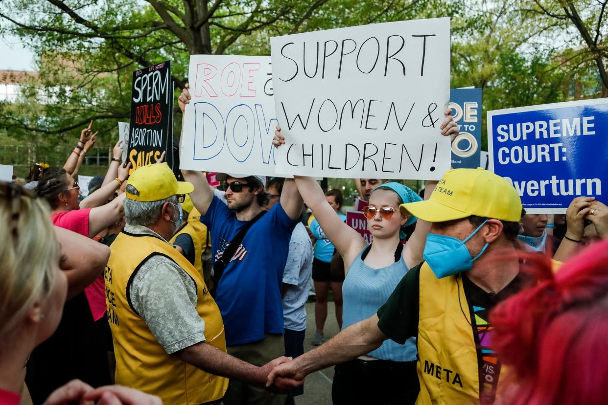 Anti-abortion activists and abortion rights activists are separated by META Peace Team members during a Bans Off Our Bodies protest at U-M's Diag in Ann Arbor on Saturday, May 14, 2022.