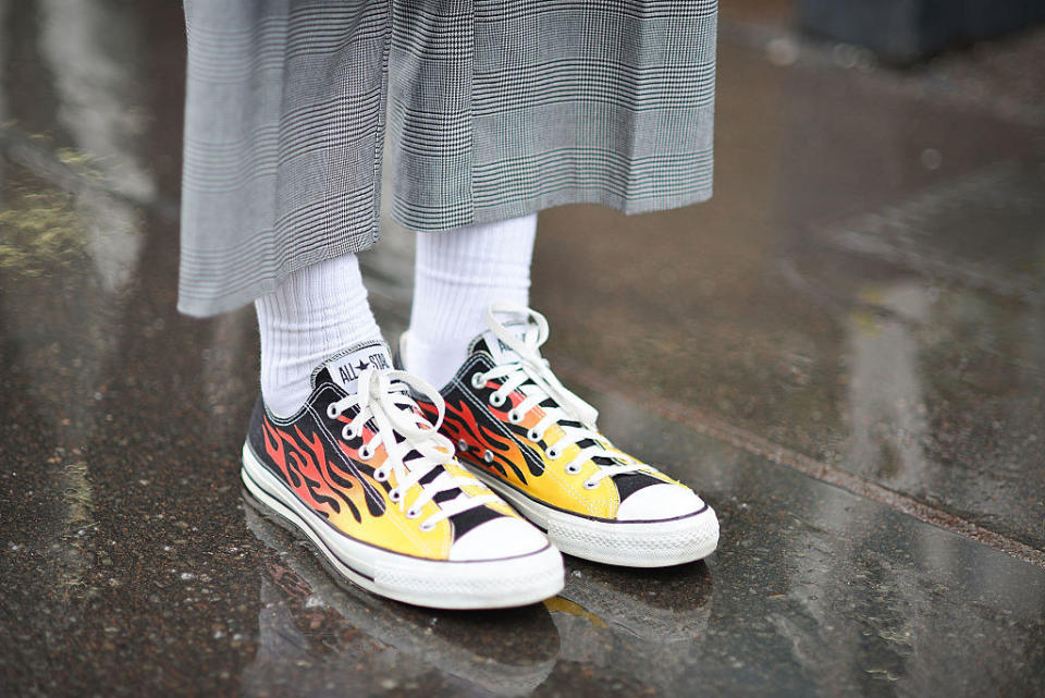 someone wearing flame designed converse