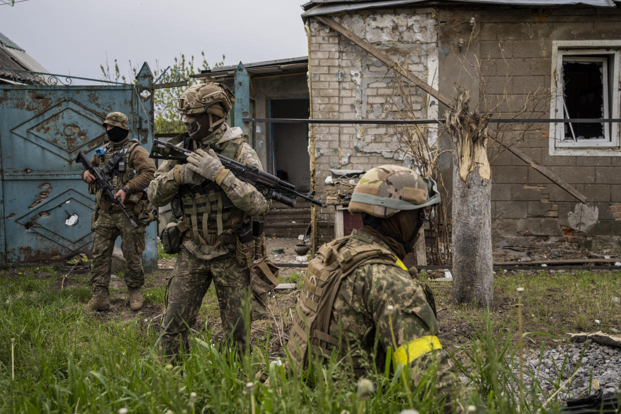 Ukrainian National Guard patrol during a reconnaissance mission in a recently retaken village on the outskirts of Kharkiv, east Ukraine, Saturday, May 14, 2022. (AP Photo/Bernat Armangue)
