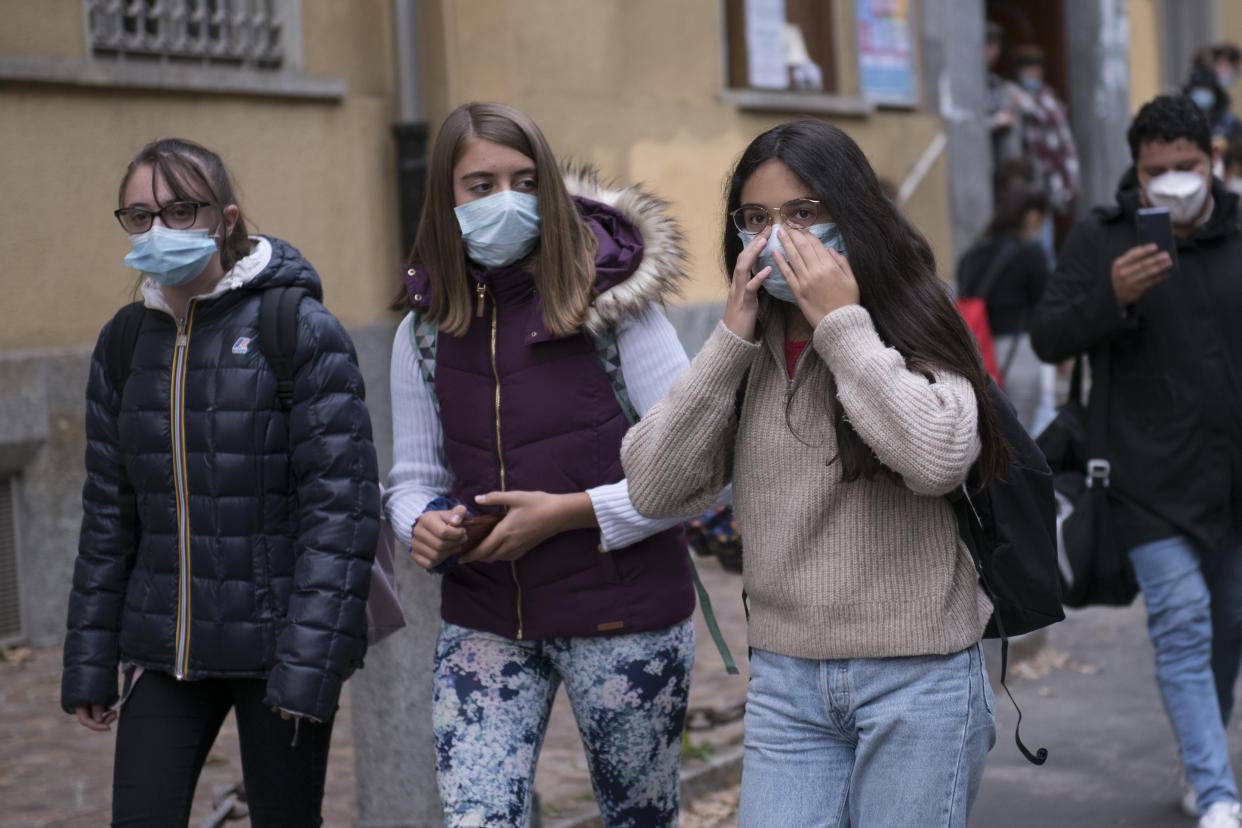 TURIN, ITALY - OCTOBER 05: Young girl wear protective mask fix the mask outside the Liceo Classico and Musicale Cavour school on October 05, 2020 in Turin, Italy. From Monday 5 October, the ordinance of the Piedmont Region introduces the obligation to wear the mask even outdoors in all pertinent areas of schools of all levels or in front of them (for example parking lots, gardens, squares and sidewalks in front at the entrances and exits of the institutes). The provision also includes all the places of waiting, boarding and disembarking of school public transport. (Photo by Stefano Guidi/Getty Images)