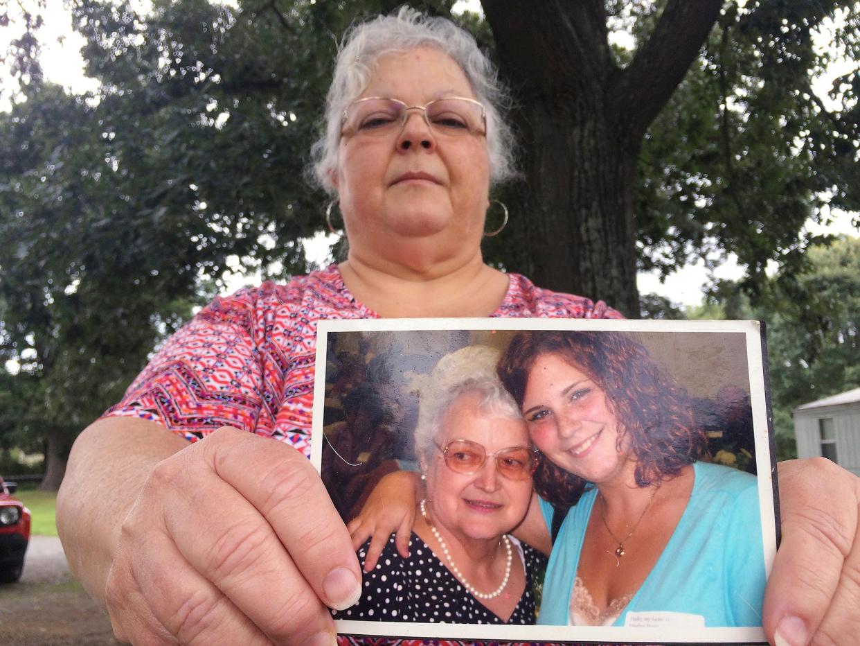 In this photo from 2017, Heather Heyer's mother Susan Bro holds a picture of her daughter and her mother. (AP)