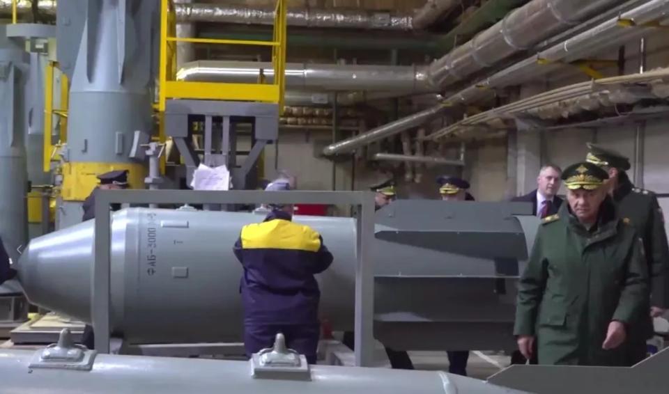 Russian Minister of Defense Sergei Shoigu, at left, inspects a munitions plant in Nizhny Novgorod in March. A standard FAB-3000M-54 bomb is seen in the background. <em>Russian MoD</em><br>