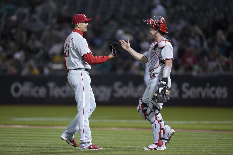 Philadelphia Phillies pitcher Andrew Vasquez, left, celebrates with catcher J.T. Realmuto after the team's 6-1 victory over the Oakland Athletics in a baseball game in Oakland, Calif., Friday, June 16, 2023. (AP Photo/Godofredo A. Vásquez)