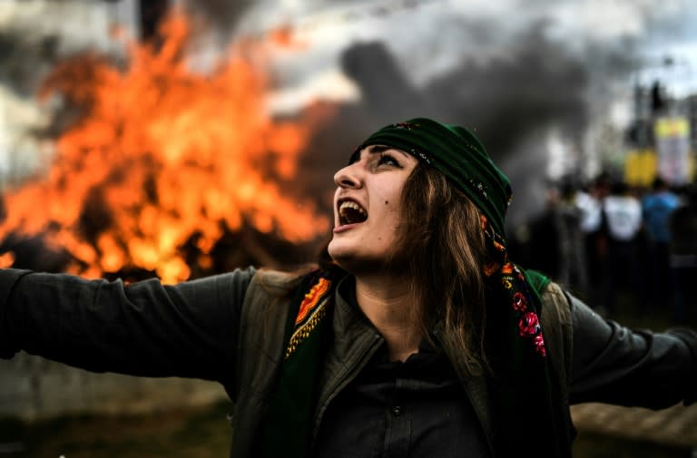 A Kurdish woman dances in front of a fire during the New Year festival of Newroz in Turkey, where Kurds make up around a quarter of its population of nearly 80 million