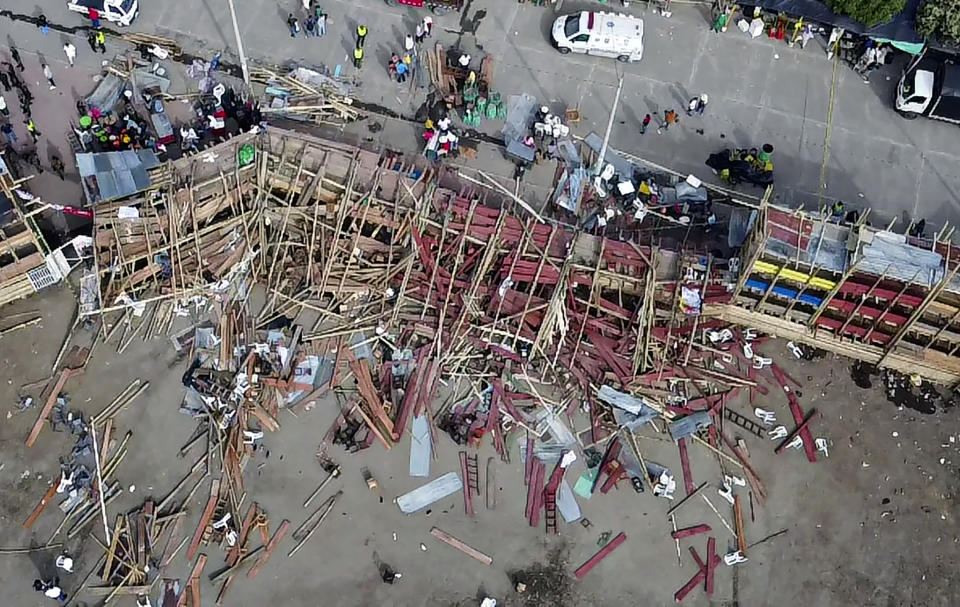 Aerial view of the collapsed grandstand in a bullring in the Colombian municipality of El Espinal, southwest of Bogotá, on June 26, 2022. - At least four people were killed and another 30 seriously injured when a full three-story section of wooden stands filled with spectators collapsed, throwing dozens of people to the ground, during a popular event at which members of the public face off with small bulls, officials said. (Photo by SAMUEL ANTONIO GALINDO CAMPOS / AFP) (Photo by SAMUEL ANTONIO GALINDO CAMPOS/AFP via Getty Images)