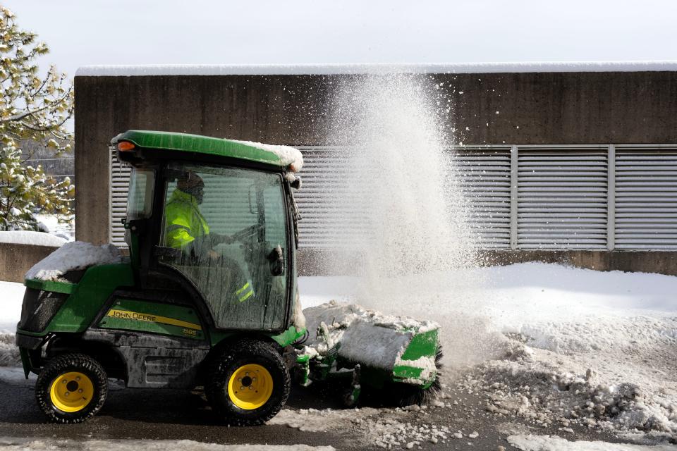 Crews remove snow from a University of Tennessee parking garage Jan. 16.