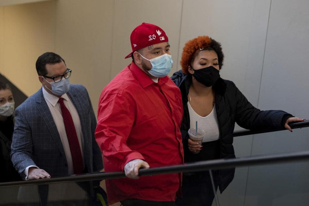 Family attorney Jeff Storms, left, accompanies the family of Daunte Wright as they arrive at the Hennepin County Government Center in Minneapolis on Wednesday, Dec. 8, 2021, as opening statements begin in the trial for former suburban Minneapolis police officer Kim Potter. (AP Photo/Christian Monterrosa)