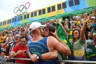 <p>Alison Cerutti of Brazil celebrates in the crowd after winning match point in the Men’s Beach Volleyball Quarterfinal match against Phil Dalhausser and Nicholas Lucena of United States on Day 10 of the Rio 2016 Olympic Games at the Beach Volleyball Arena on August 15, 2016 in Rio de Janeiro, Brazil. (Photo by Matthias Hangst/Getty Images) </p>