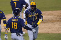 Milwaukee Brewers' Orlando Arcia (3) celebrates his two-run home run with Keston Hiura during the fourth inning in Game 1 of the team's National League wild-card baseball series against the Los Angeles Dodgers on Wednesday, Sept. 30, 2020, in Los Angeles. (AP Photo/Ashley Landis)