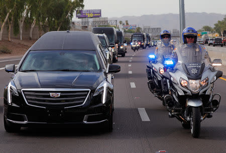 A motorcade carries the casket of Senator John McCain from the Arizona State Capitol to a memorial service in Phoenix, Arizona, U.S., August 30, 2018. REUTERS/Brian Snyder