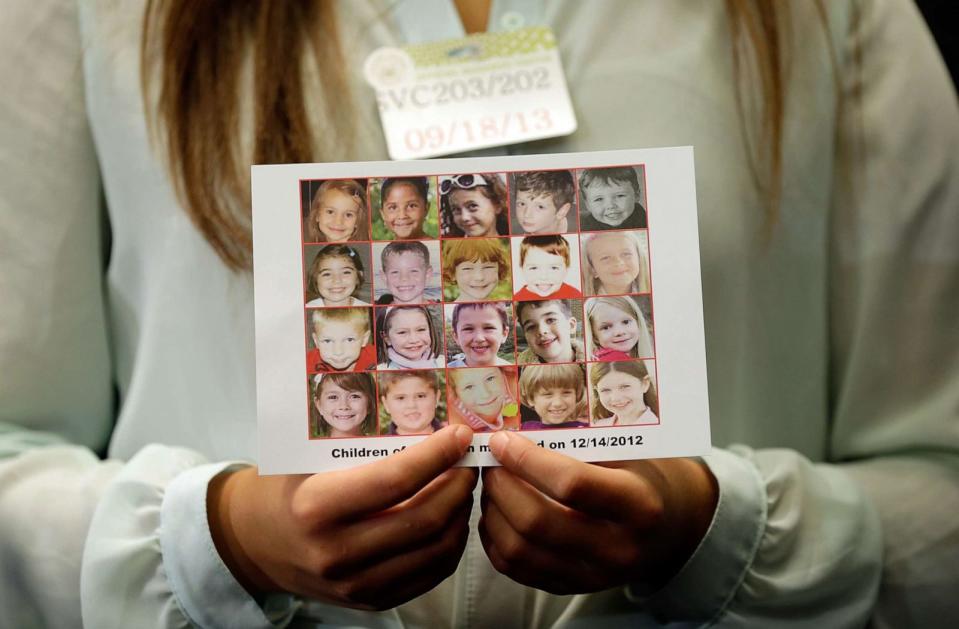 PHOTO: Kyra Murray holds a photo with victims of the shooting at Sandy Hook Elementary School during a press conference at the U.S. Capitol calling for gun reform legislation, Sept. 18, 2013, in Washington, DC. (Win Mcnamee/Getty Images, FILE)